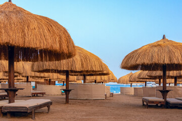 Beach landscape, view of the sandy beach and recreation area, equipped with wide thatched...