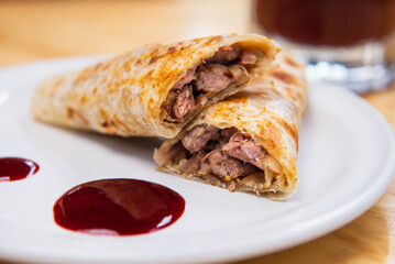 Mexican burrito and michelada beer with tomato juice with copy space. Michelada beer with tomato juice and burritos. Mexican food on wooden table. Concept of traditional food and mexican drink.