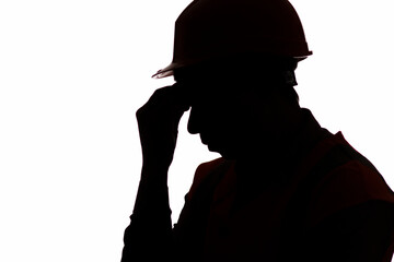 silhouette of tired builder bowed head in emotional stress on white isolated background, male...