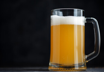 Wheat beer mug on black background, copyspace