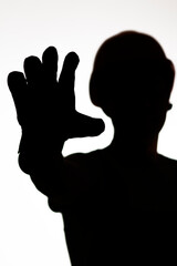 silhouette of construction worker in hardhat showing palm forbidding gesture stop, warning hand sign, protest concept