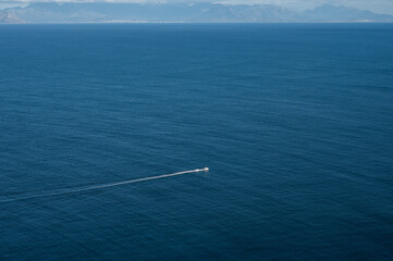 Tiny motor boat with wake in the sea