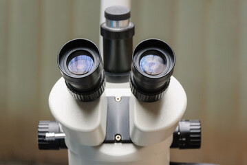 Eyepieces of a medical microscope in a dental office .
