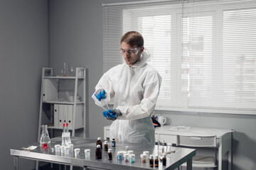 Young male chemist experimenting in a lab