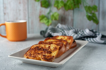French toast with tea on a gray background. Healthy breakfast concept.