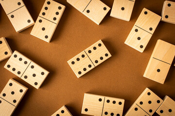 A game of dominoes on a brown background. Close-up. Selective focus.