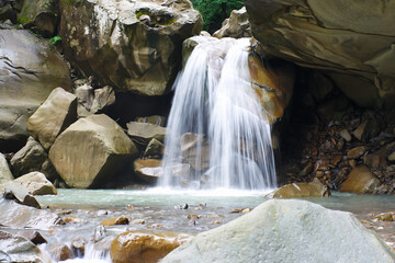 Marvellous powerful streams of water falling from cliff.
