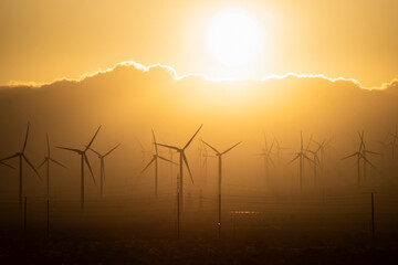 wind energy turbine with windmills and  Orange sky sunset