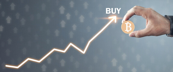 Male hand holding bitcoin. Buy cryptocurrency. Man invests in bitcoin