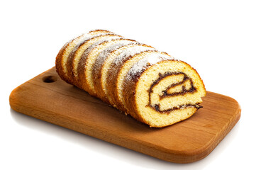 Uncut biscuit roll with fruit jam and powdered sugar on a wooden cutting board, isolate. Homemade baked goods.