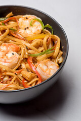 Ramen noodles with corn in a black bowl