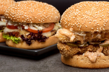 Set burgers with potatoes on the dark background
