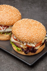 Set burgers with potatoes on the dark background