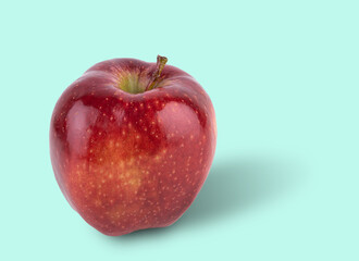 juicy red delicious apple on a light blue background. Front view