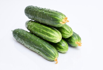 ripe short-fruited cucumbers on a white background