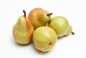 four ripe pears on a white background