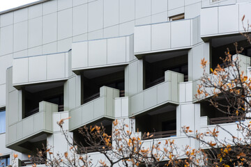 Ventilated grey facade. Abstract architectural background. Square geometric pattern of tiles on the...