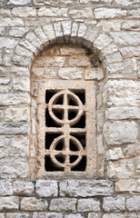 Antique decorative stone window built into the stone wall