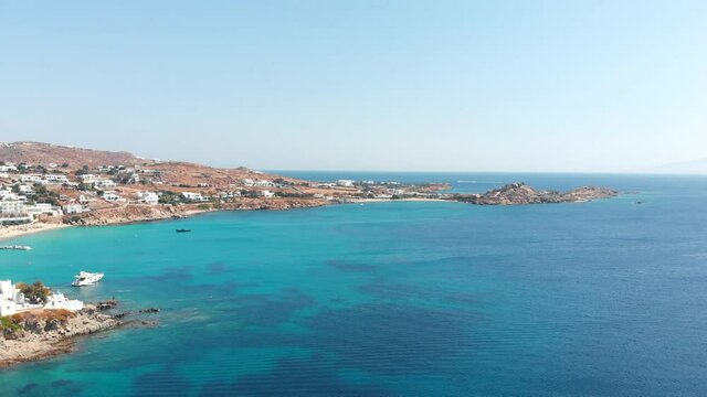 Aerial panoramic rotating view of the famous Platis Gialos Mykonos beach Cyclades Greece.