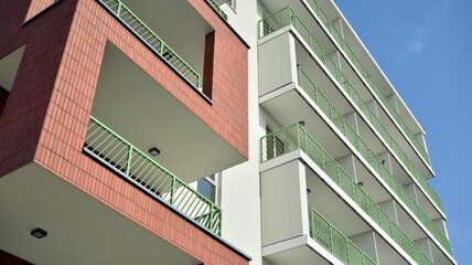 Fototapeta premium Part of city real estate property and condo architecture. Detail in modern residential flat apartment building exterior. Fragment of New luxury house and home complex. 