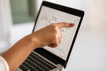 Black Business woman using laptop for analyzing data stock market, forex trading graph, stock exchange trading online, financial investment concept. close up