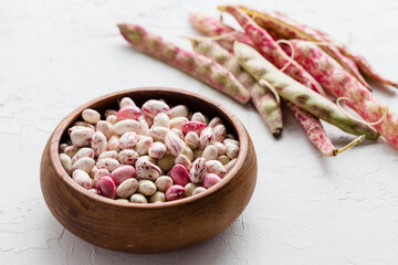 Colorful Pink and White Shelled Cranberry Borlotti Beans in Wooden Bowl with Shell Beans in Background