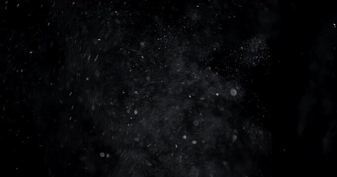 Golden glitter background in slow motion.  real dust particles floating in the air.  Universe gold dust with stars on black background.