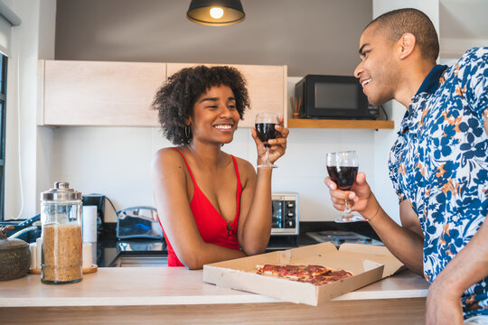 Happy Latin Couple Having Dinner At Home.