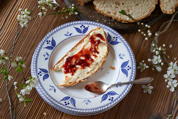 A slice of mazanec, traditional Czech sweet Easter pastry, with butter and jam