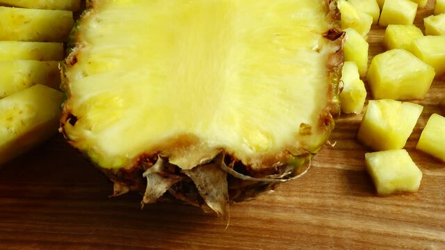 Pieces of pineapple on a cutting wooden board.