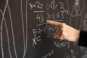 Mathematical formulas on dark black chalk board