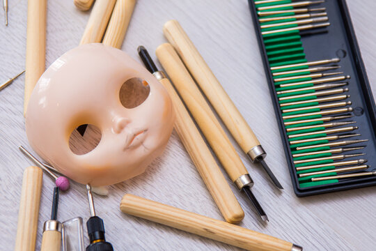 Creating the doll's face. A girl creates the image of a Blythe doll