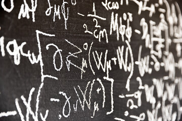 Mathematical formulas on dark black chalk board