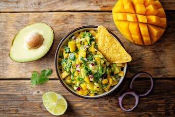 Mango Guacamole with corn chips and ingredients to prepare it
