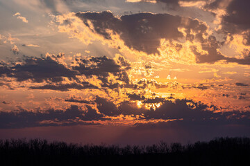 A beautiful orange, pink, yellow and purple sunset and clouds.