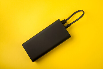 Black Power Bank with adapter for charging mobile devices. Power Bank close-up.