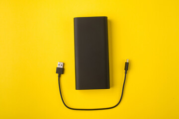 Black Power Bank with adapter for charging mobile devices. Power Bank close-up.