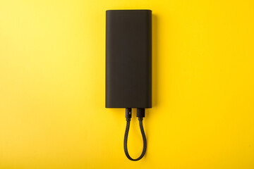 Black Power Bank with adapter for charging mobile devices. Power Bank close-up.