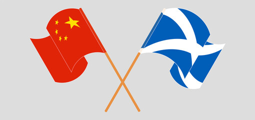 Crossed and waving flags of China and Scotland