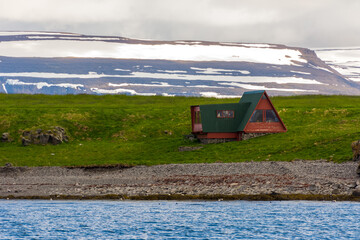 isolated wooden house on Vigur island, on the north western coast of Iceland during summer season