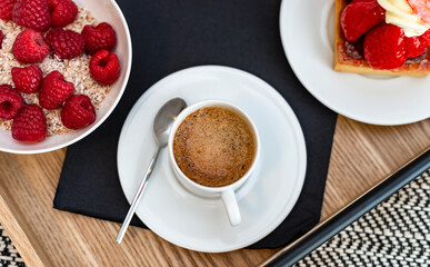 Breakfast in bed. Raspberries, coffee, cake, croissant. Cozy hotel.