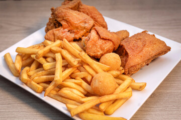 chicken and french fries on a white plate