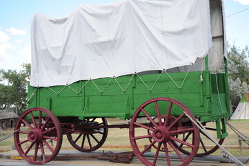 Covered wagon displayed outdoors.