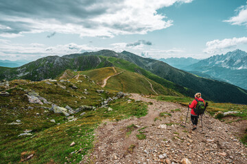 Fototapeta premium Backpacker on hiking trails in the Dolomites, Italy.