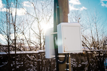 Electric shield transformer under voltage. Winter day outside the city. Sunny day in cold weather.