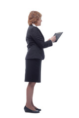 Side view of senior stylish businesswoman writing on clipboard