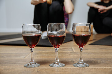 three glasses with wine on the background of people