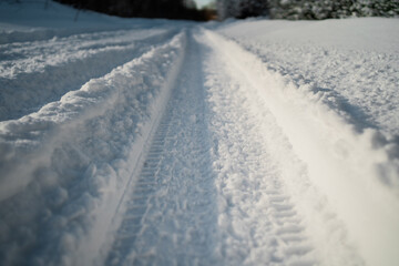 Large snowdrifts in the cold season. Snow road in the forest. Winter day outside the city. Sunny day in cold weather.