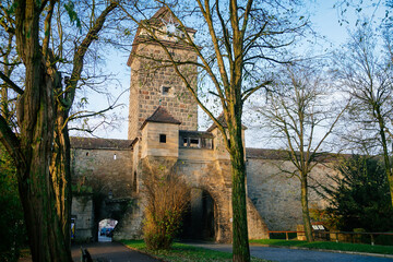 Fototapeta na wymiar Parkanlage garden park near Galgentor, Old Town fortification, gothic stone tower and city walls at sunny autumn day, Rothenburg ob der Tauber, Bavaria, Germany
