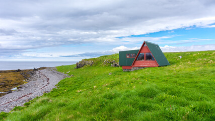 isolated wooden house on Vigur island, on the north western coast of Iceland during summer season